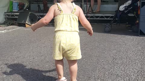 Toddler looks like she's had too much to drink whilst doing an Irish jig