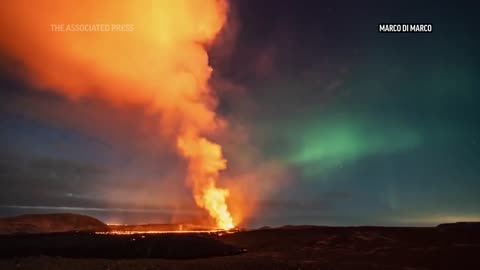 Northern Lights shine over erupting volcano in Iceland