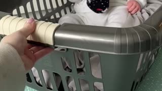 Baby in a washing basket.