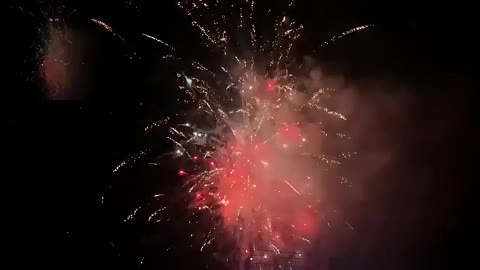 Hundreds of fireworks burst simultaneously in midair