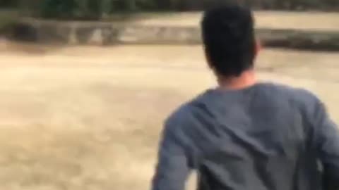 Guy runs and does backflip, kicks person holding camera