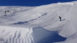 Snowboarder rides down hill and tries to flip off ramp hits head