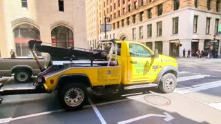 Tow Truck Driver Tries to Steal Car Stopped at a Stoplight in Downtown San Francisco