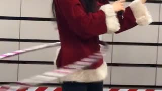 Woman santa costume hula hoop playing violin