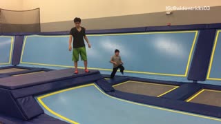 Music black shirt backflip on blue trampoline lands on head