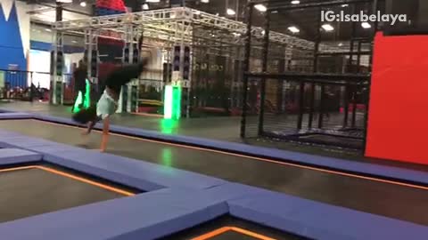 Girl does cartwheel flip inside of trampoline center and lands on head