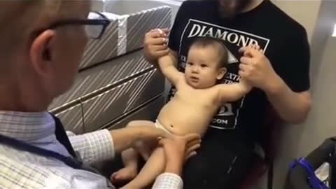 doctor distracts the baby to get the vaccine