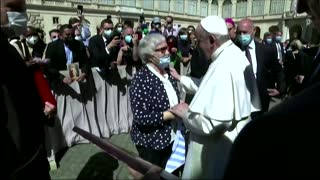 Pope kisses survivor's concentration camp tattoo