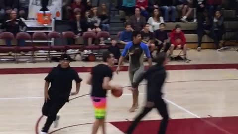 Teen in wetsuit shoots free throws in a gymnasium