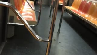 Man picking his bare feet on empty subway train