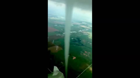 Plane flies around funnel cloud