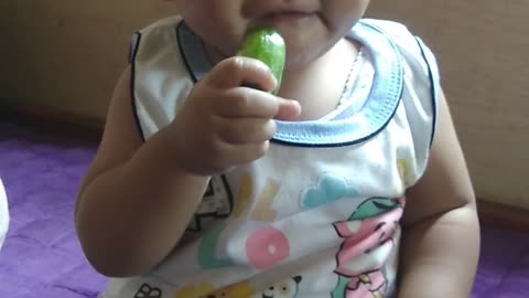 A baby who tries to eat a very sour starfruit