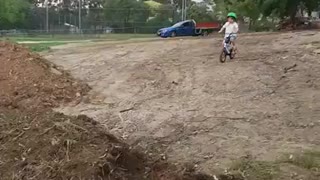 Green helmet boy bike hill faceplant