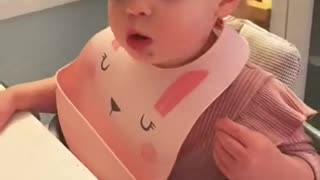 Baby's first bite of pizza