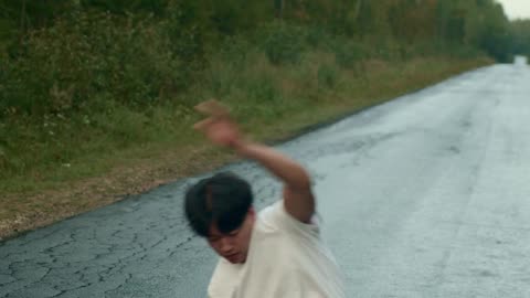 Man Breakdancing in the Middle of the Road