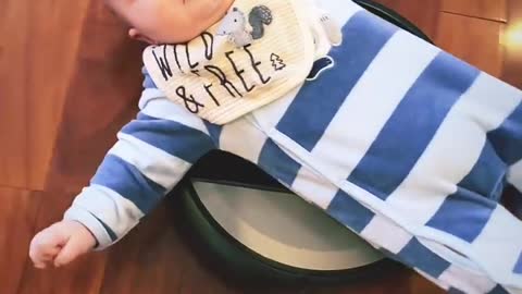 Baby Laying on a Roomba