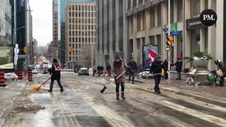 Freedom protestors in Ottawa shovel a street