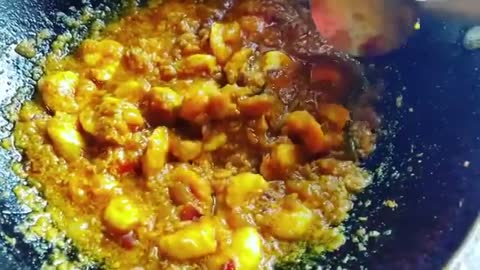 Person Cooks Shrimp Curry Using Three Spices And Coconut