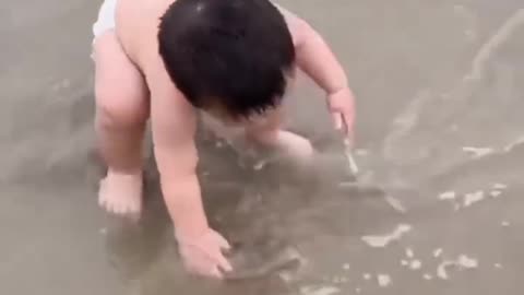 Funny baby reaction on beach