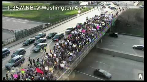 Minneapolis, MN: pro abortion activists are marching across the Washington Avenue bridge