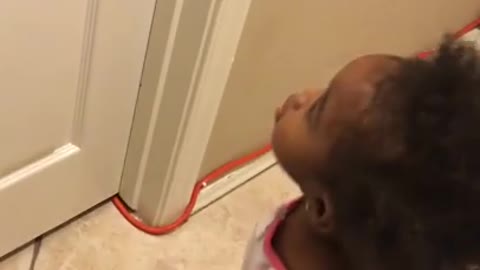 Toddler really wants her dad to open the door!