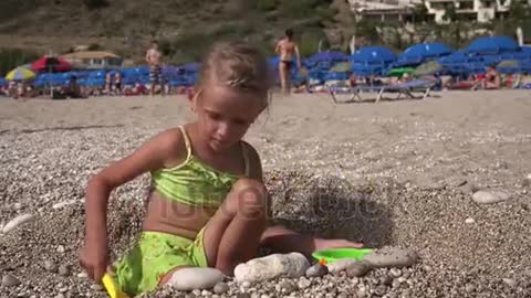 child playing in sea sand beach little girl on tropical exotic sea coastline bay kid in summer