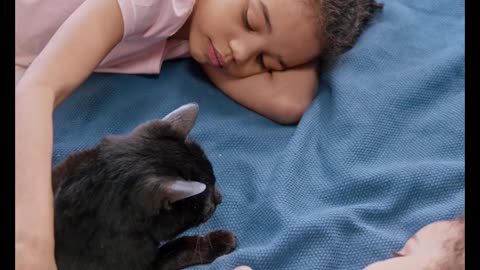 Kids Petting Their Cat On The Bed