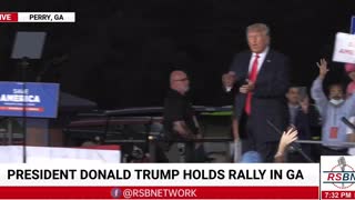 Trump walks out to a raucous crowd for his rally in Perry, Georgia