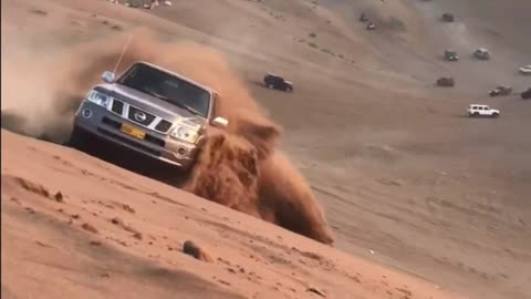 car sailing in the sand Nissan Petrol