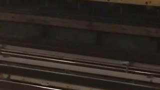 Man in a green sweater dancing in a subway station