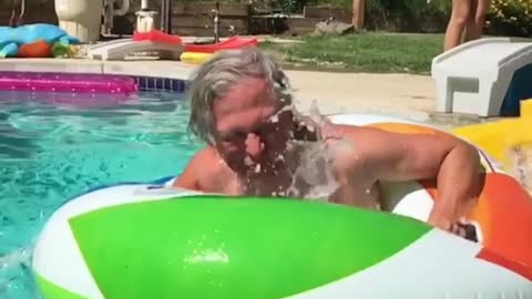 Collab copyright protection - old guy floatie into pool slide