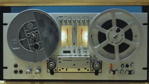 Retro audio tape recorder in motion