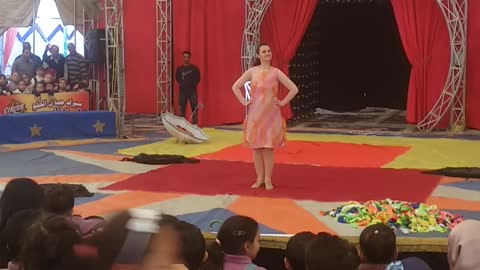 A circus model who changes her clothes on stage with amazing speed