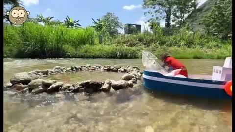 Little monkey catching fish by the river outdoors
