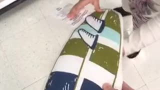 Guy holding surf pillow kid knocks it out off his hand