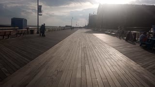 Skateboarding on long beach boardwalk