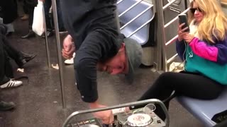 Man hangs upside down subway car with dj set
