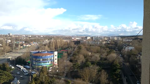 Blue sky and snow clouds over the city.