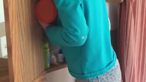 Girl hides her face after using her mother's makeup