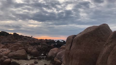 A Beautiful Time Lapse Video of People Walking on a Rocky Coast