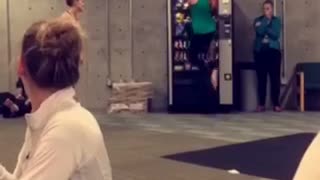 Girl in green jumps into a vending machine