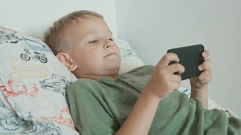 Boy Playing on His Smartphone