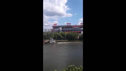 Tugboat Pushes Barge Down River