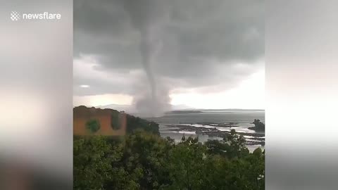 Huge waterspout forms off the coast of Indonesia
