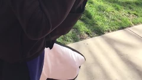 Guy carries surfboard in a giant bag