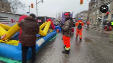 Amid a heavy police presence, a bouncy castle is being set up at the freedom protest in Ottawa