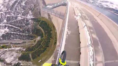 Man cycling on steep cliffs 200 meters too dangerous