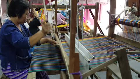 Thai woman weaving fabric