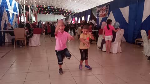 The two beautiful children dance and play with joy and happiness