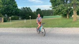 Caring chicken goes for a bike ride with owner